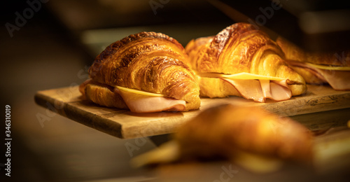 Ham and cheese croissants on a wooden tray