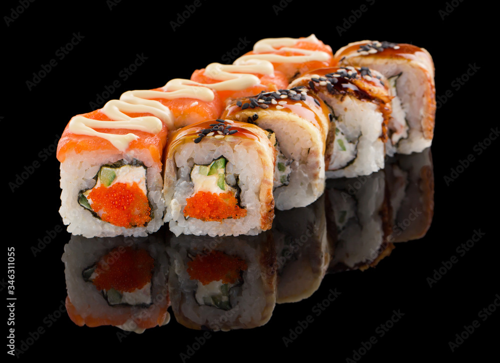 Set of Two different Sushi roll with salmon, cheese, cucumber, tobiko caviar, eel, sauce and sesame isolated on black background with reflection Set of Two different Sushi roll with salmon, cheese, cucumber, tobiko caviar, eel, sauce and sesame isolated on black background with reflection