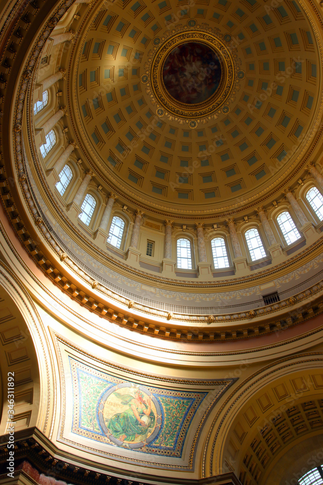 Madison Wisconsin Capitol building fragment interior with lighted by penetrating sun beautiful historical mosaic wall decor Liberty on northeast side of dome and rotunda sealing with windows.