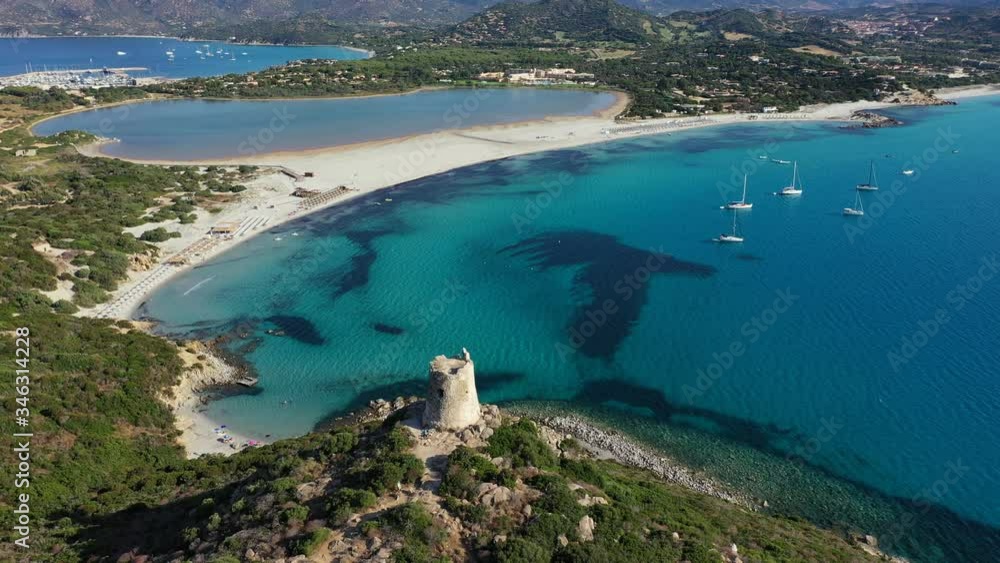 Torre di Porto Giunco Tower and Simius Beach near Villasimius, Sardinia, Italy. View from flying drone. Torre di Porto Giunco tower on Carbonara cape. Aerial morning view of Sardinia island, Italy Torre di Porto Giunco Tower and Simius Beach near Villasimius, Sardinia, Italy. View from flying drone. Torre di Porto Giunco tower on Carbonara cape. Aerial morning view of Sardinia island, Italy