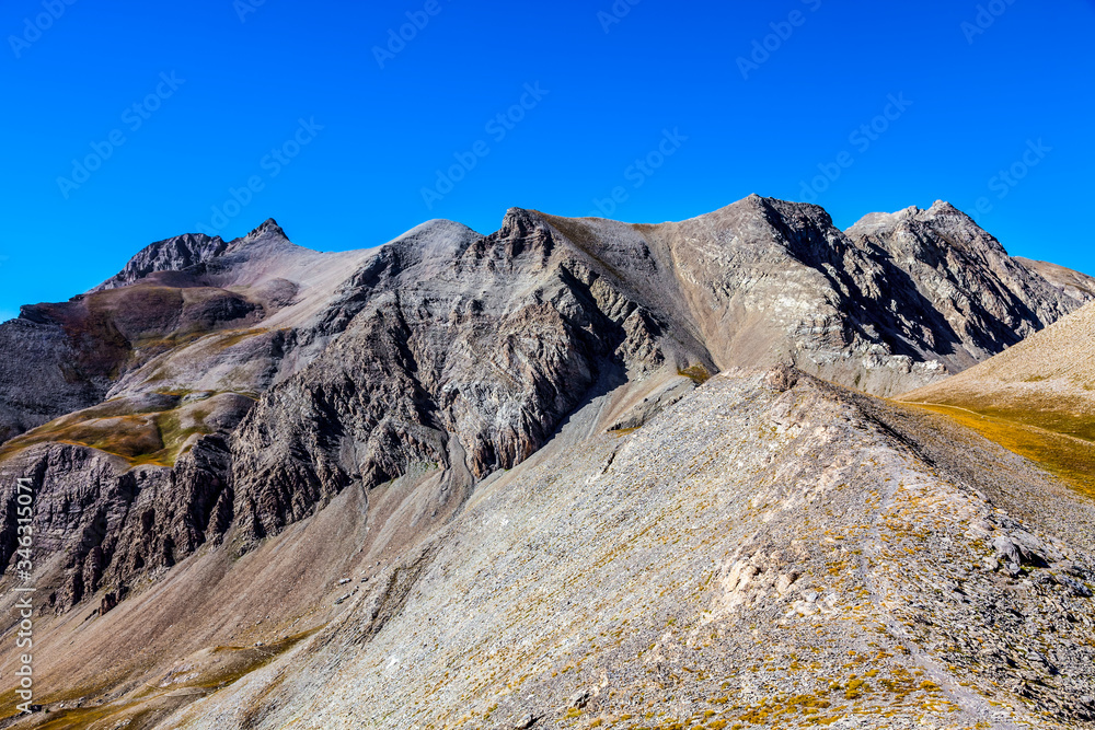 Image of a high altitude footpath in rocky mountains in the Southern French Alps.