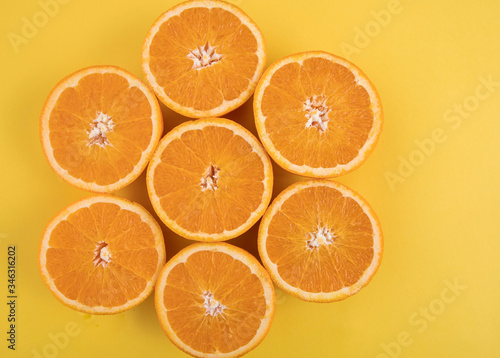 Orange on an orange background. Halves of juicy orange.