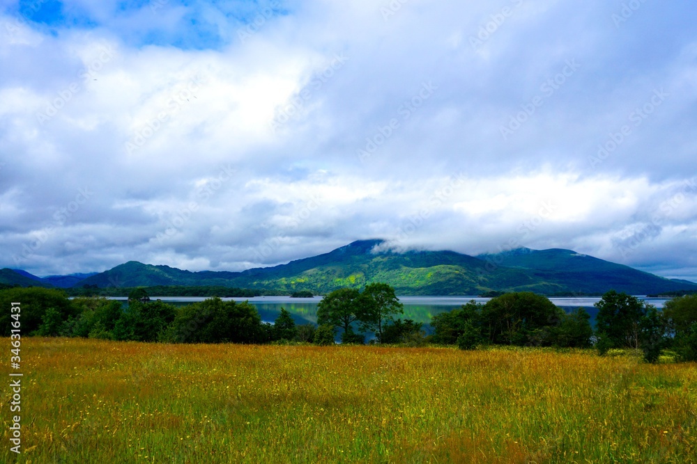 Beautiful Irish landscape with peaceful lake and rugged mountain.