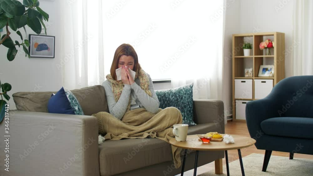 healthcare, cold, allergy and people concept - sick woman blowing her runny nose in paper tissue at home healthcare, cold, allergy and people concept - sick woman blowing her runny nose in paper tissue at home