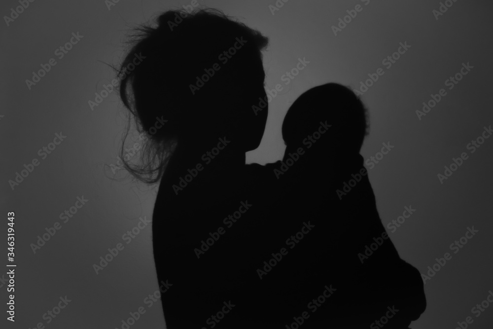 Silhouette Of Happy Mother and Baby. Mom and baby hugging to eachother, Happy Mother's Day concept