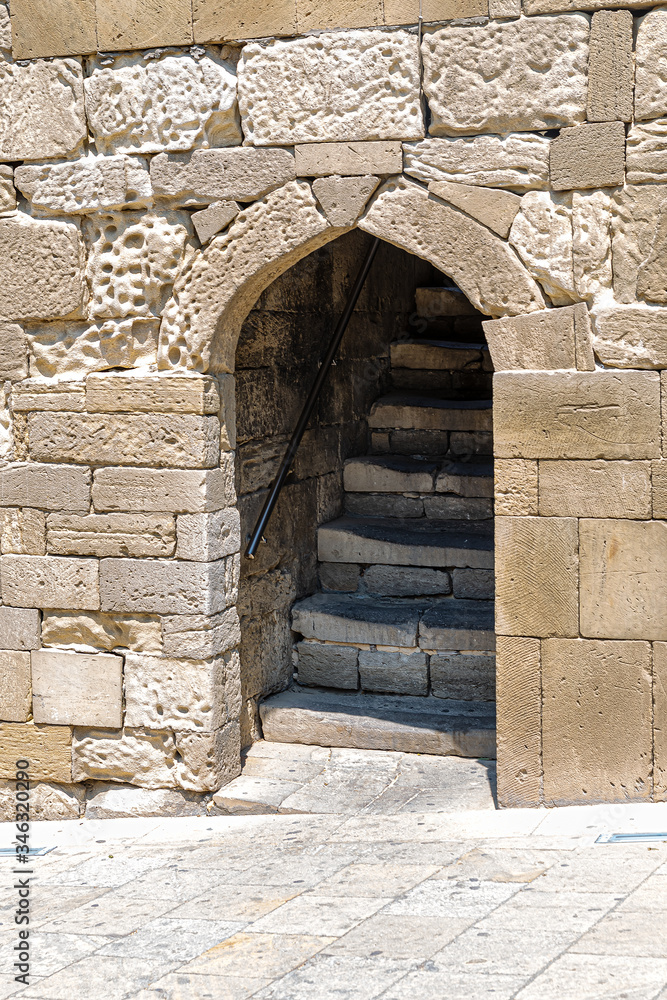 Arched opening and staircase in the old stone wall of the old city of Baku