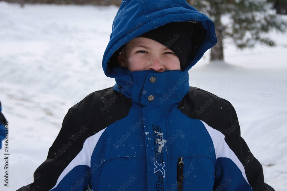 snow coat winter child nose eyes blue black white tree outside nature