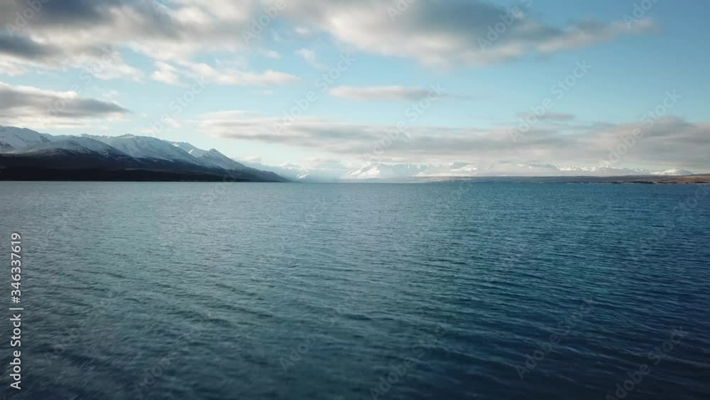 Cinematic Aerial View of Lake Pukaki, New Zealand. Glacial Water Under Beautiful Sky and Mount Cook Cinematic Aerial View of Lake Pukaki, New Zealand. Glacial Water Under Beautiful Sky and Mount Cook