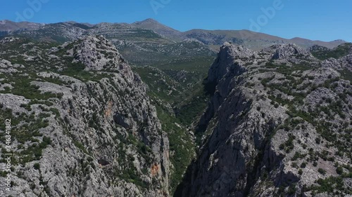 Paklenica Canyon in South Velebit Mountain revealing Vaganski Peak behind - Aerial Panoramic Blue Sky View photo