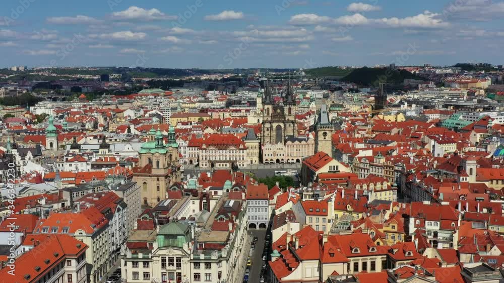 Prague beautiful panoramic sunny aerial drone view above Prague Old Town Square with Church of Our Lady before Tyn and Prague Astronomical Clock Tower. Drone flight over red roofs of Prague, Czechia. Prague beautiful panoramic sunny aerial drone view above Prague Old Town Square with Church of Our Lady before Tyn and Prague Astronomical Clock Tower. Drone flight over red roofs of Prague, Czechia.