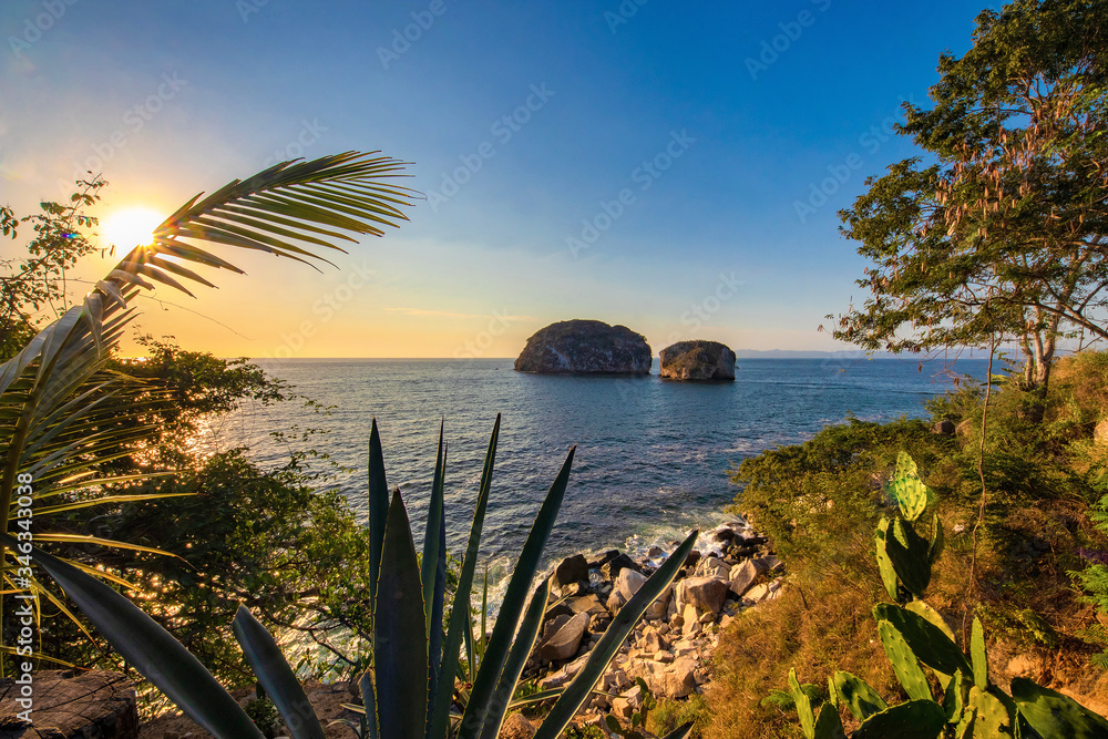 Tropical beach sunset with islets