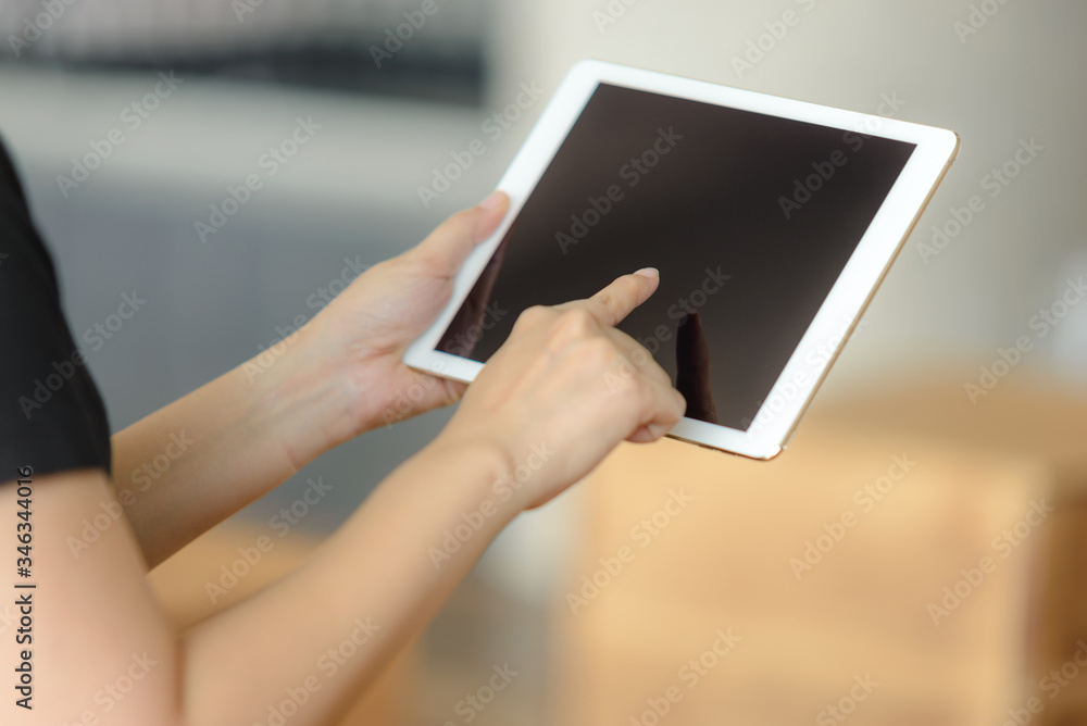 Close-up of businesswoman using a digital tablet Close-up of businesswoman using a digital tablet