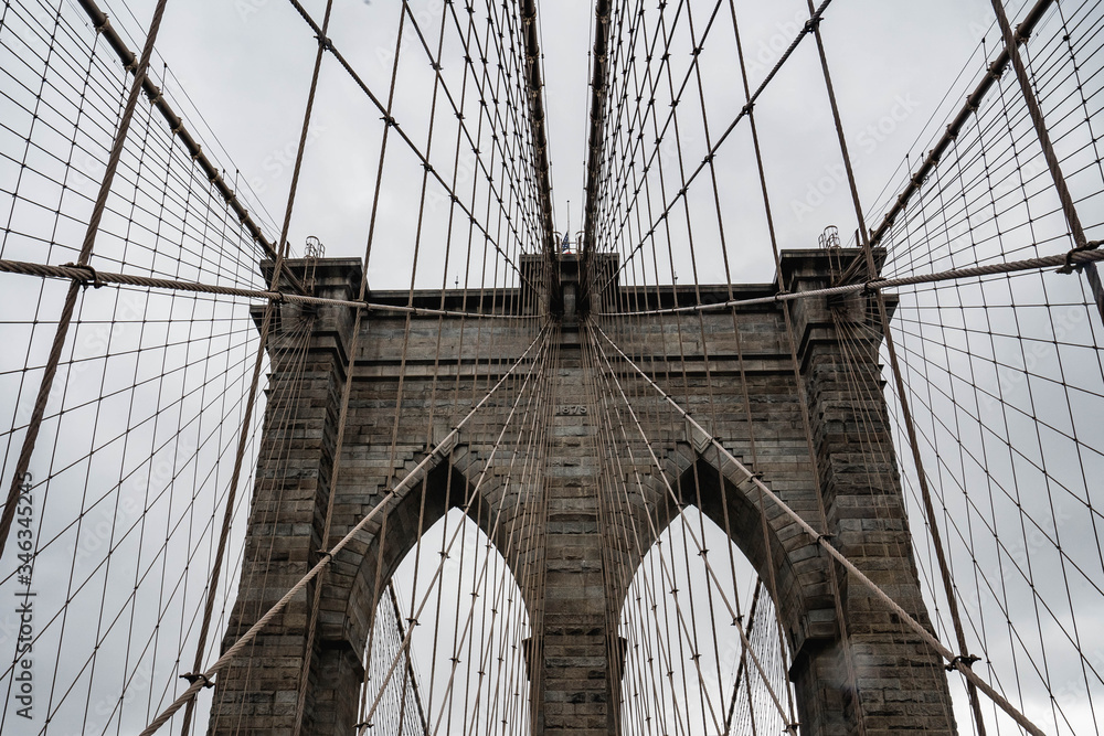 Naklejka premium Brooklyn bridge. Rainy Brooklyn bridge view. Brooklyn bridge close up view. Rainy day at Brooklyn bridge. 