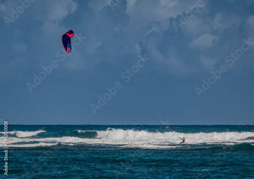 Kite surfer approaches large wave in Dominica Republic