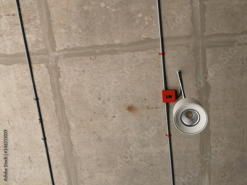 luminaire installed inside the building with a concrete surface ceiling