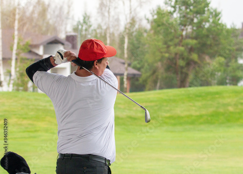 Player a during a golf game during a hit
