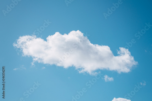 Single cloud flying in the deep blue sky 