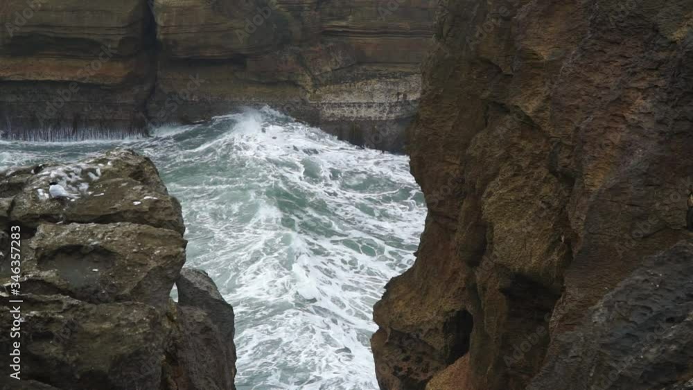 Tidal ocean waves hitting Punakaiki Pancake Rocks, New Zealand Tidal ocean waves hitting Punakaiki Pancake Rocks, New Zealand
