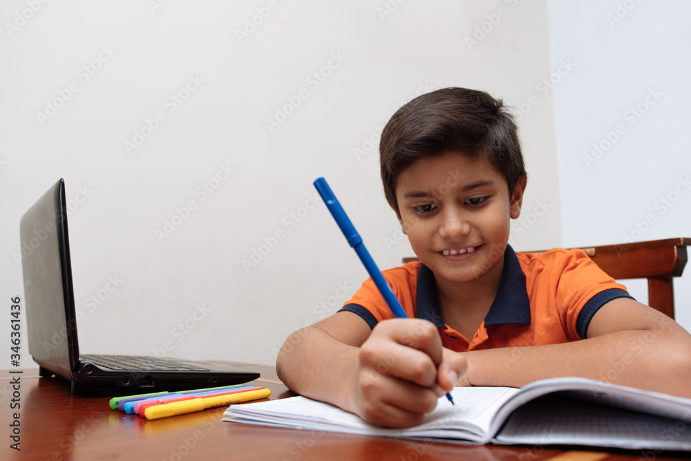 Child using a laptop during isolation from the coronavirus outbreak. Distance education, home education, online education Child using a laptop during isolation from the coronavirus outbreak. Distance education, home education, online education