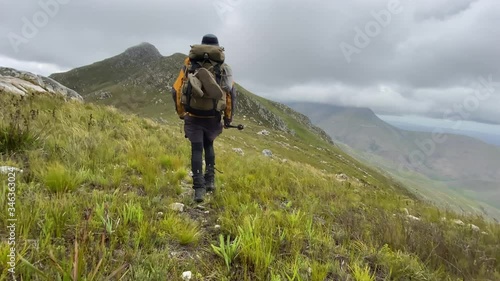 Hiking alone during cloudy day, epic journey in South African mountains, lifetime experience photo