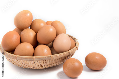 Eggs in a wooden basket on a white background.