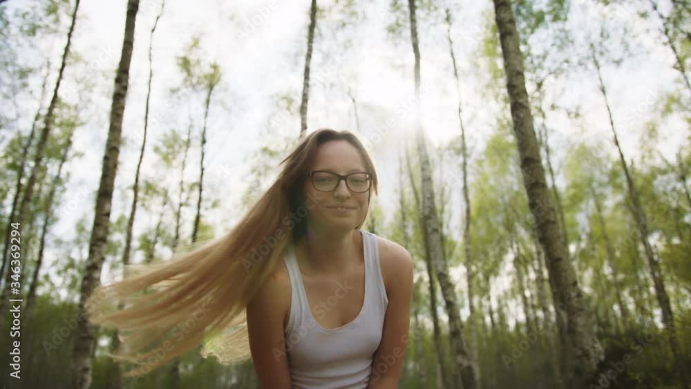 Young caucasian girl casually dressed spinning in the forest with a big smile. freedom concept. Young caucasian girl casually dressed spinning in the forest with a big smile. freedom concept.
