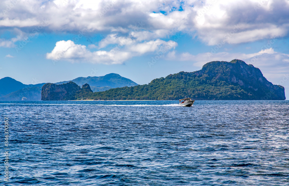 Pleasure boat on the waves of the Indian ocean near El Nido island. Palawan, Philippines