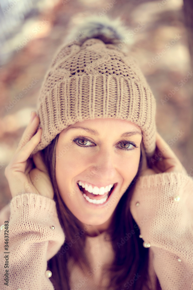 Smiling young girl with wool cap in autumn, winter Smiling young girl with wool cap in autumn, winter