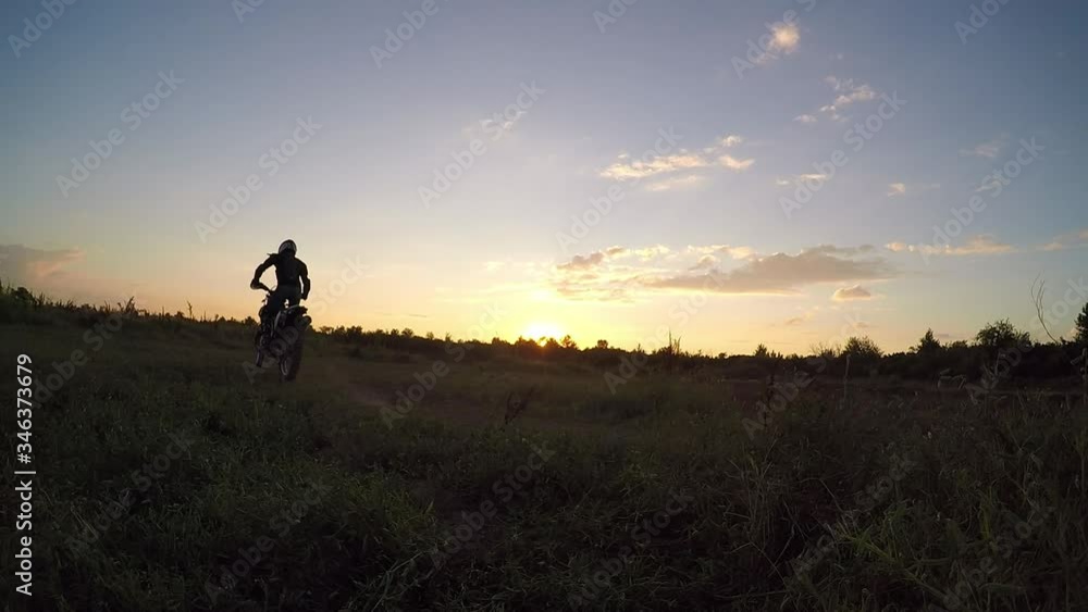 Motorcyclists ride on a gravel road in the mountains. Moto biker driving a motorcycle on a rocky road. Motorcyclists ride on a gravel road in the mountains. Moto biker driving a motorcycle on a rocky road.