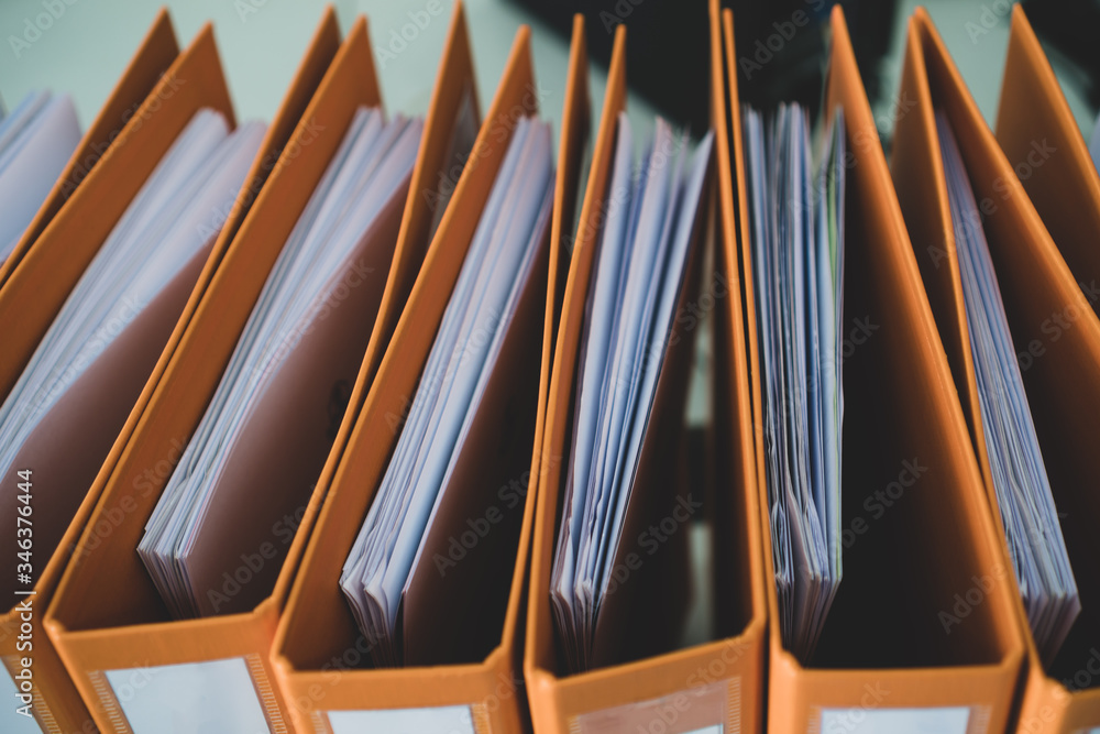 Document binder file folders stack on office desk in organization with report paper, paperwork record label, A lot of work information for businessman or lawyer organized archive database bookkeeping Document binder file folders stack on office desk in organization with report paper, paperwork record label, A lot of work information for businessman or lawyer organized archive database bookkeeping