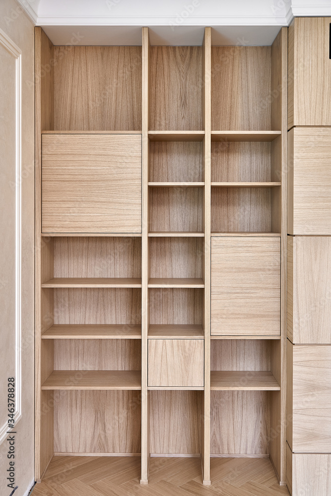 Wooden bookshelves. Wooden bookcases and wall panels made of oak veneered MDF Wooden bookshelves. Wooden bookcases and wall panels made of oak veneered MDF