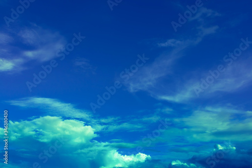 Overcast blue sky with green blue light in soft clouds
