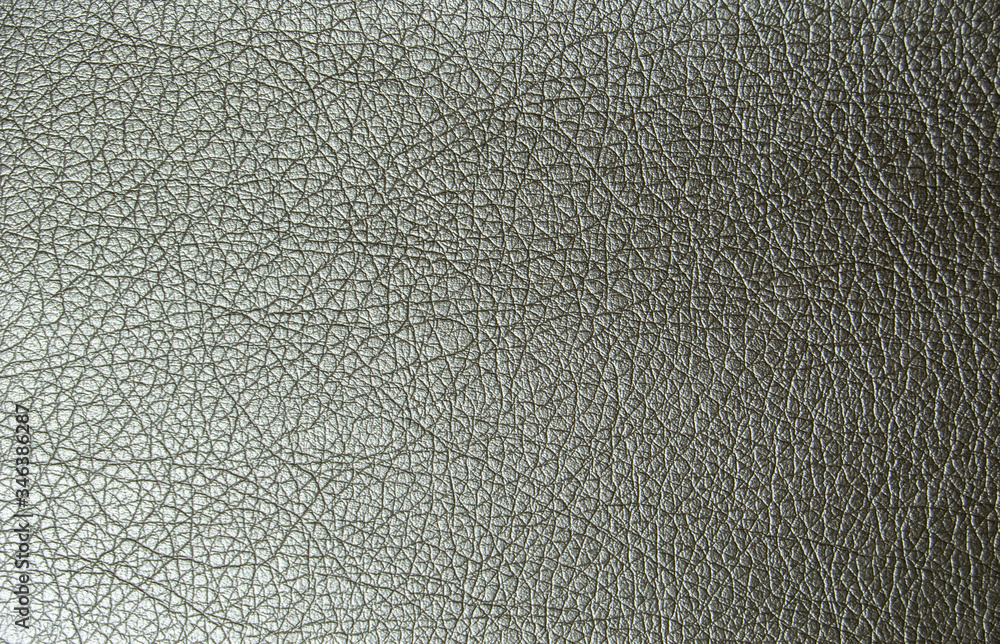 The texture of artificial leather is a shade of gold metallic. Artificial leather close-up The texture of artificial leather is a shade of gold metallic. Artificial leather close-up