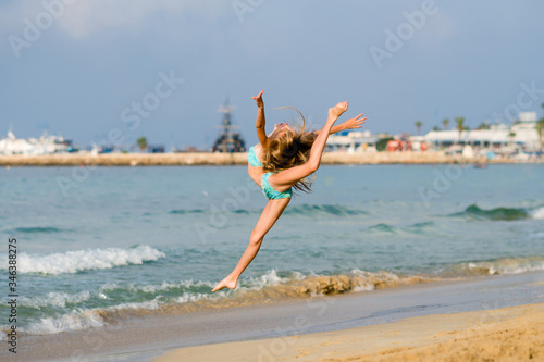 happy girl jumping on the beach