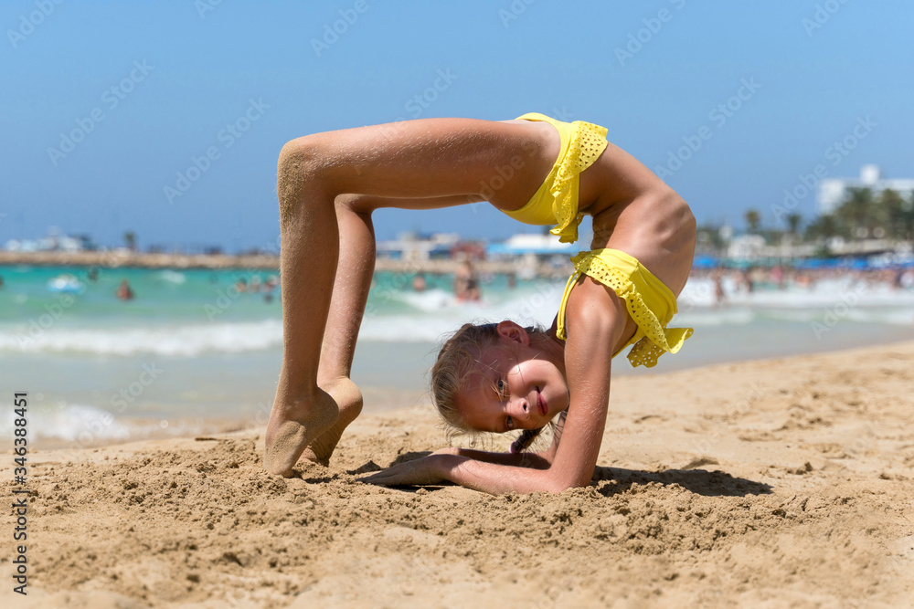 girl doing yoga exercises on the beach Stock Photo