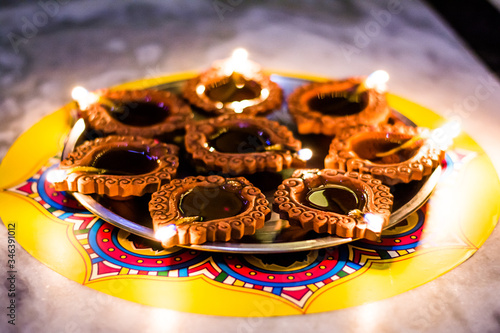 Happy Diwali - Colorful clay diya lamps lit during diwali celebration
 photo