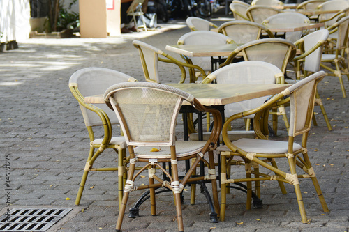 row of wicker chairs and tables in the cafe