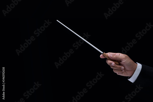 Orchestra conductor hands baton. Hands of conductor holding stick on a black background
