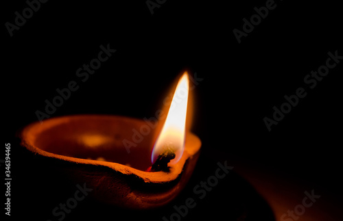 Happy Diwali - Colorful clay diya lamps lit during diwali celebration 