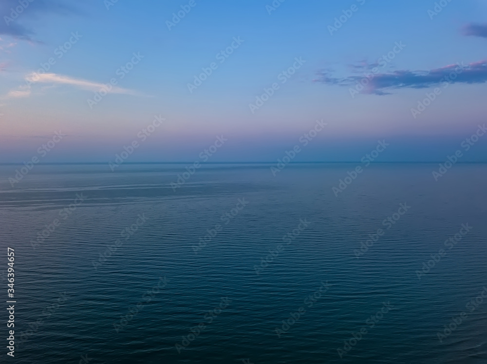 Aerial panoramic view of sunrise over sea. Nothing but sky, clouds and water. Beautiful serene scene Aerial panoramic view of sunrise over sea. Nothing but sky, clouds and water. Beautiful serene scene