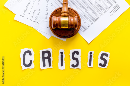 Bankruptcy, financail crisis - judge gavel - on yellow background top view photo