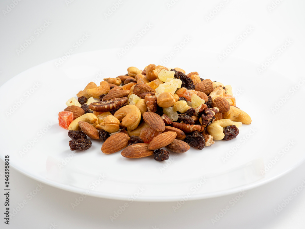 Mix of various nuts and dried fruit on white, Almonds, Raisins, Nuts, top view.. Mix of various nuts and dried fruit on white, Almonds, Raisins, Nuts, top view..