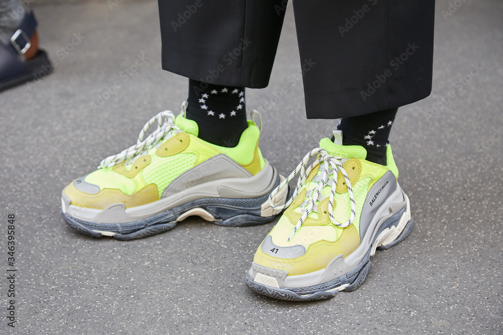 Man with yellow green Balenciaga shoes and black socks with white stars on  June 16, 2018 in Milan, Italy foto de Stock | Adobe Stock