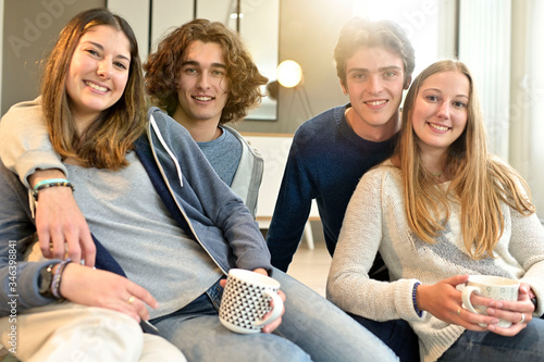 Group of friends sitting on floor of shared apartment photo