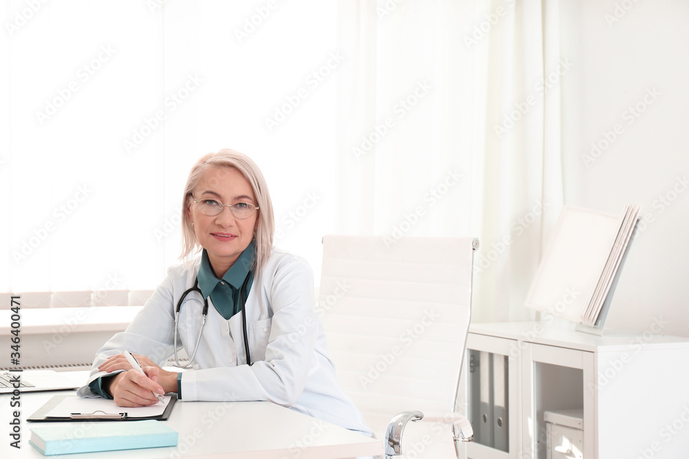 Portrait of mature female doctor in white coat at workplace Portrait of mature female doctor in white coat at workplace