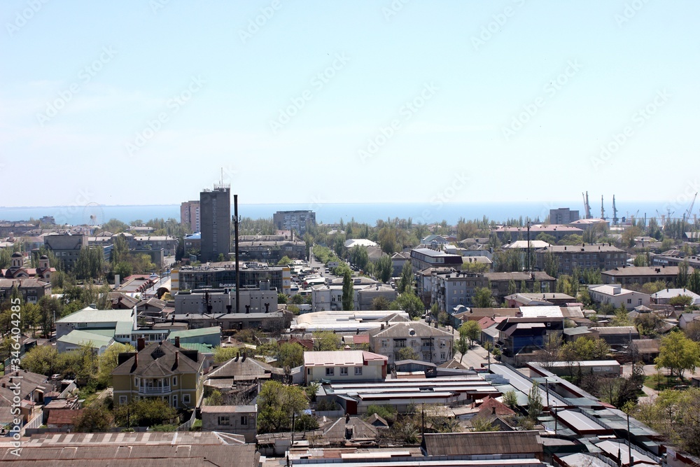 View of the city from above, the sea in the distance. City and sea on the horizon. Open space.