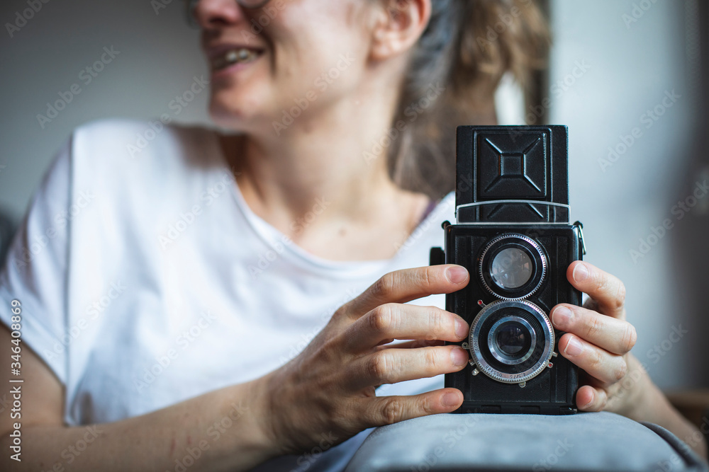 Photographer prepares her vintage analog medium format camera.
