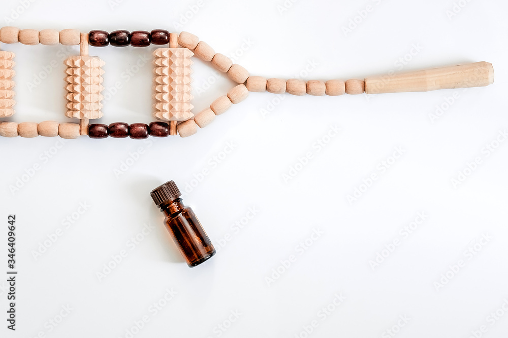 Massage accessories on a white background. Items for Spa treatments. Hand massager and massage oil on a white background.Wooden set for anti-cellulite manual massage. Massage accessories on a white background. Items for Spa treatments. Hand massager and massage oil on a white background.Wooden set for anti-cellulite manual massage.