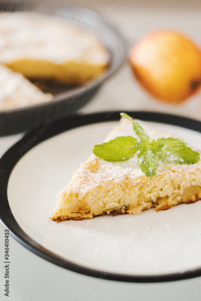 Slice of homemade apple pie with powdered sugar and fresh mint. Traditional dessert Slice of homemade apple pie with powdered sugar and fresh mint. Traditional dessert