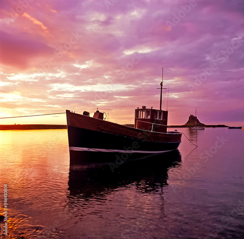 Colourful dawn at the small harbour at Lindisfarne Holy Island Northumberland photo